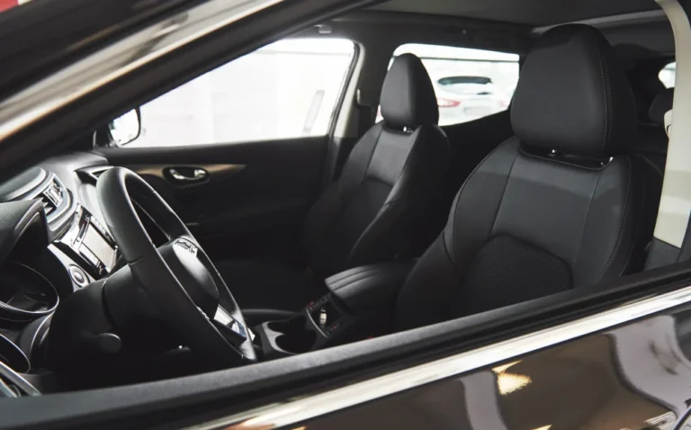 Intérieur de SUV avec sièges en cuir noir et tableau de bord moderne.